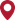 A red location pin icon with a small black dot in the center.