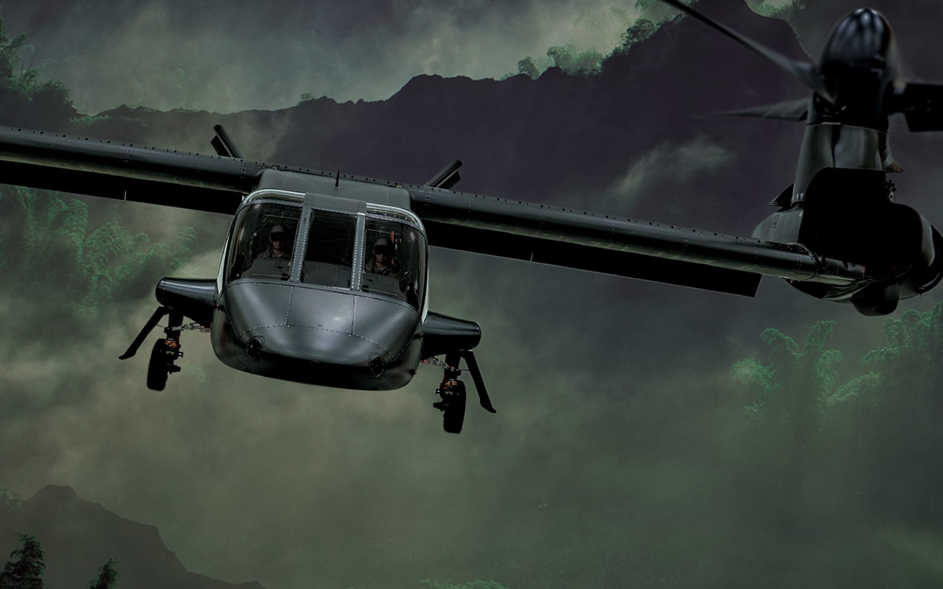 Military helicopter flying over a misty forest landscape.