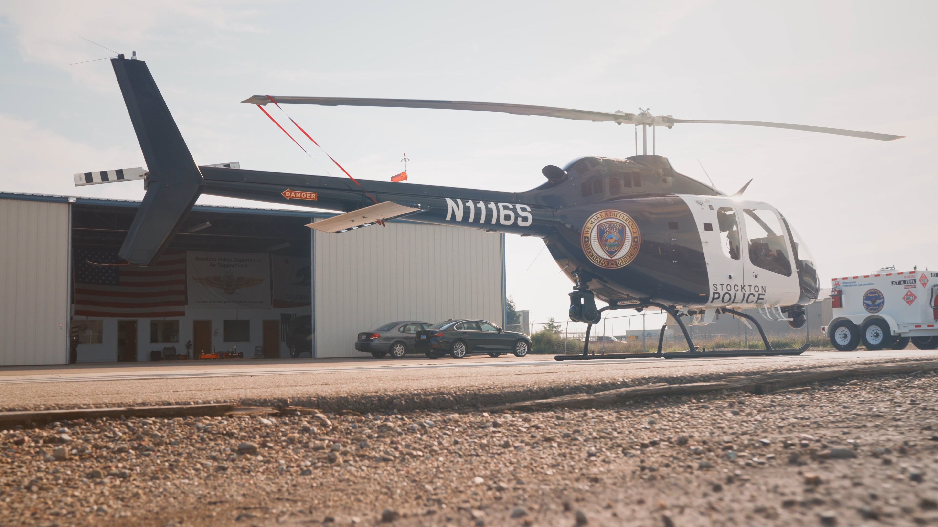 Stockton Police Department Bell 505 in front of hangar.