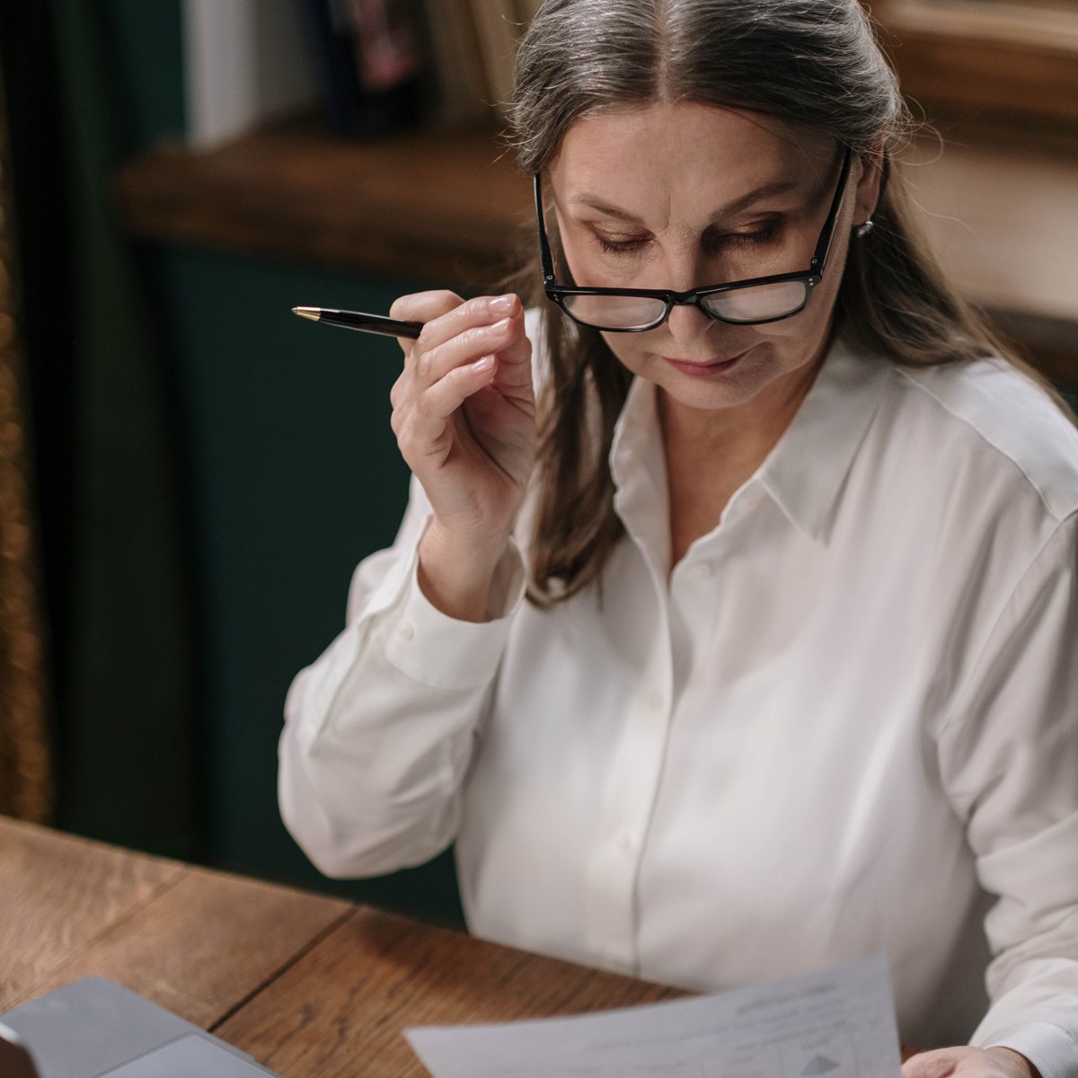A job seeker reviewing a printed resume at a desk