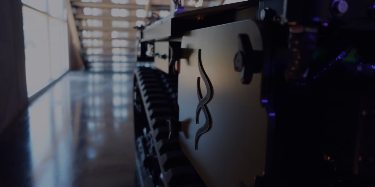 jEKYLL tracked unmanned ground vehicle in an indoor corridor, close-up of the track and hull