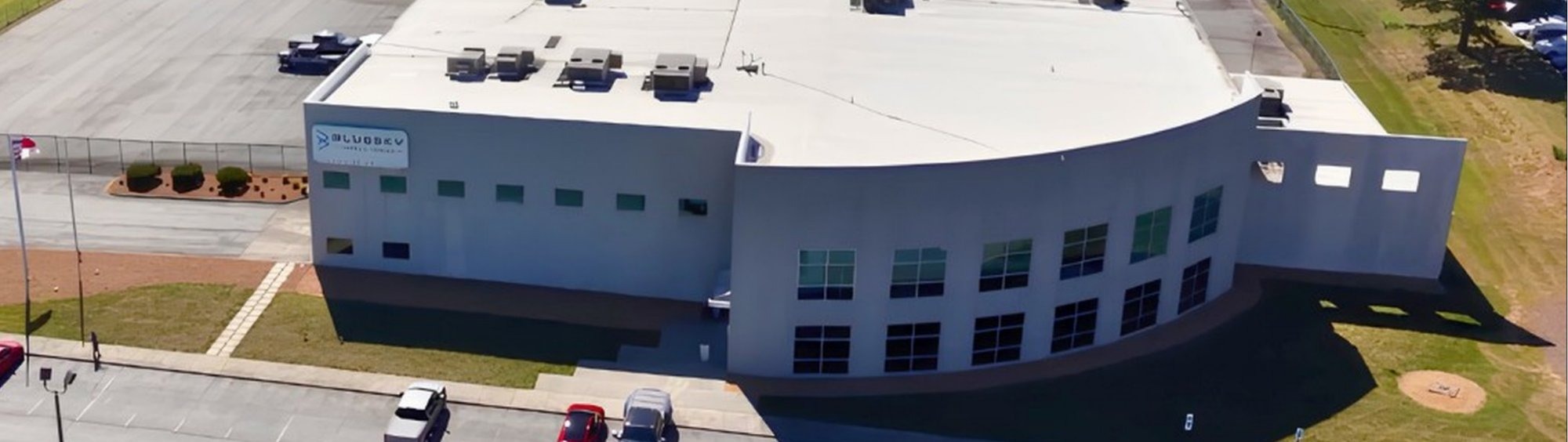 Aerial view of the BlueSky Mobile Power manufacturing facility in Lexington, NC, showing the glass entrance and sign