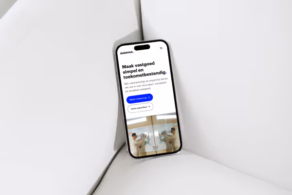 Smartphone displaying a Dutch real estate website on a white cushioned surface.