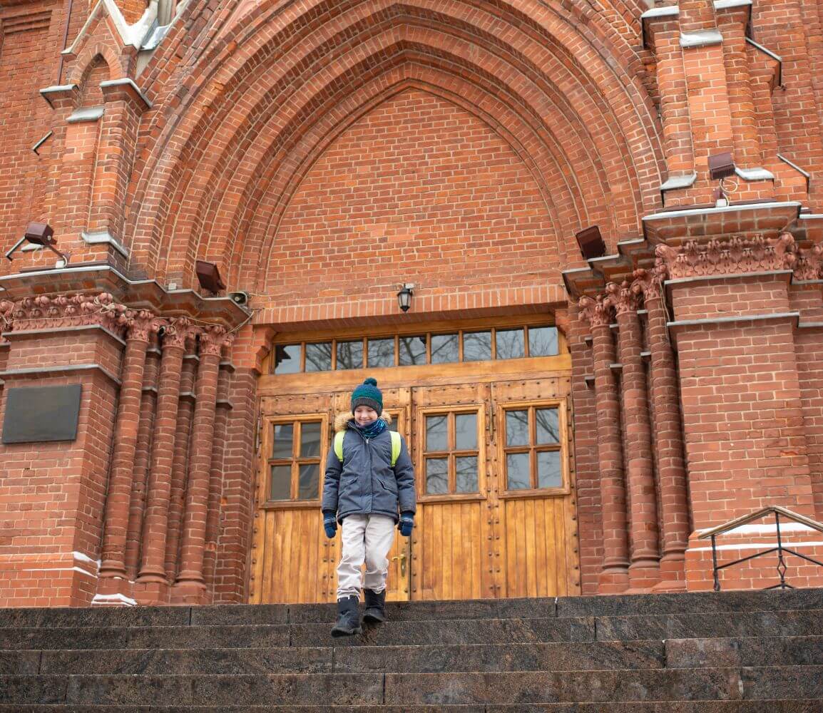 a person standing on a set of stairs in front of a building