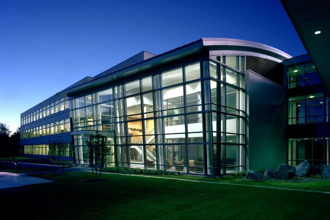 a large glass building lit up at night