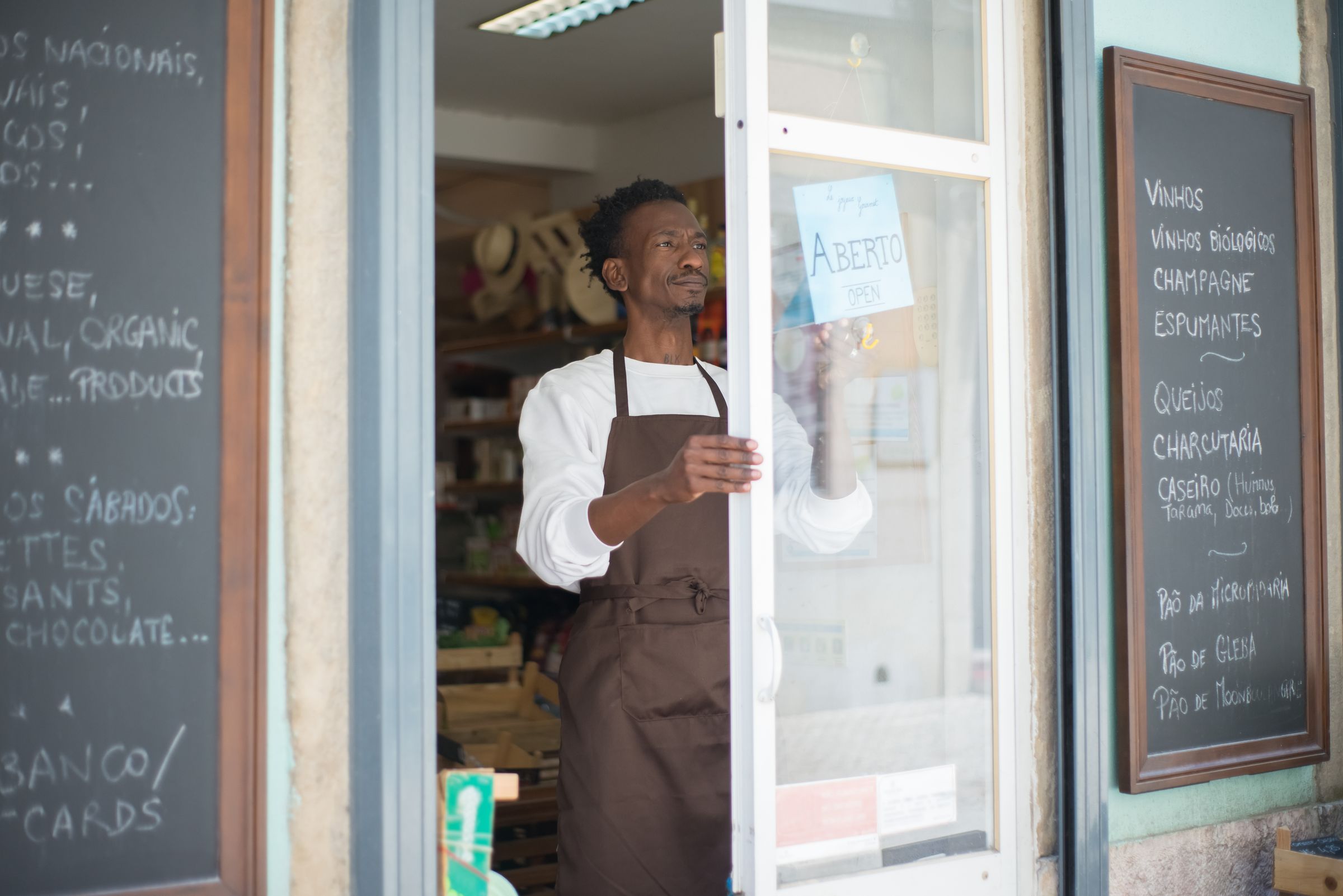 Shop owner opening his storefront door