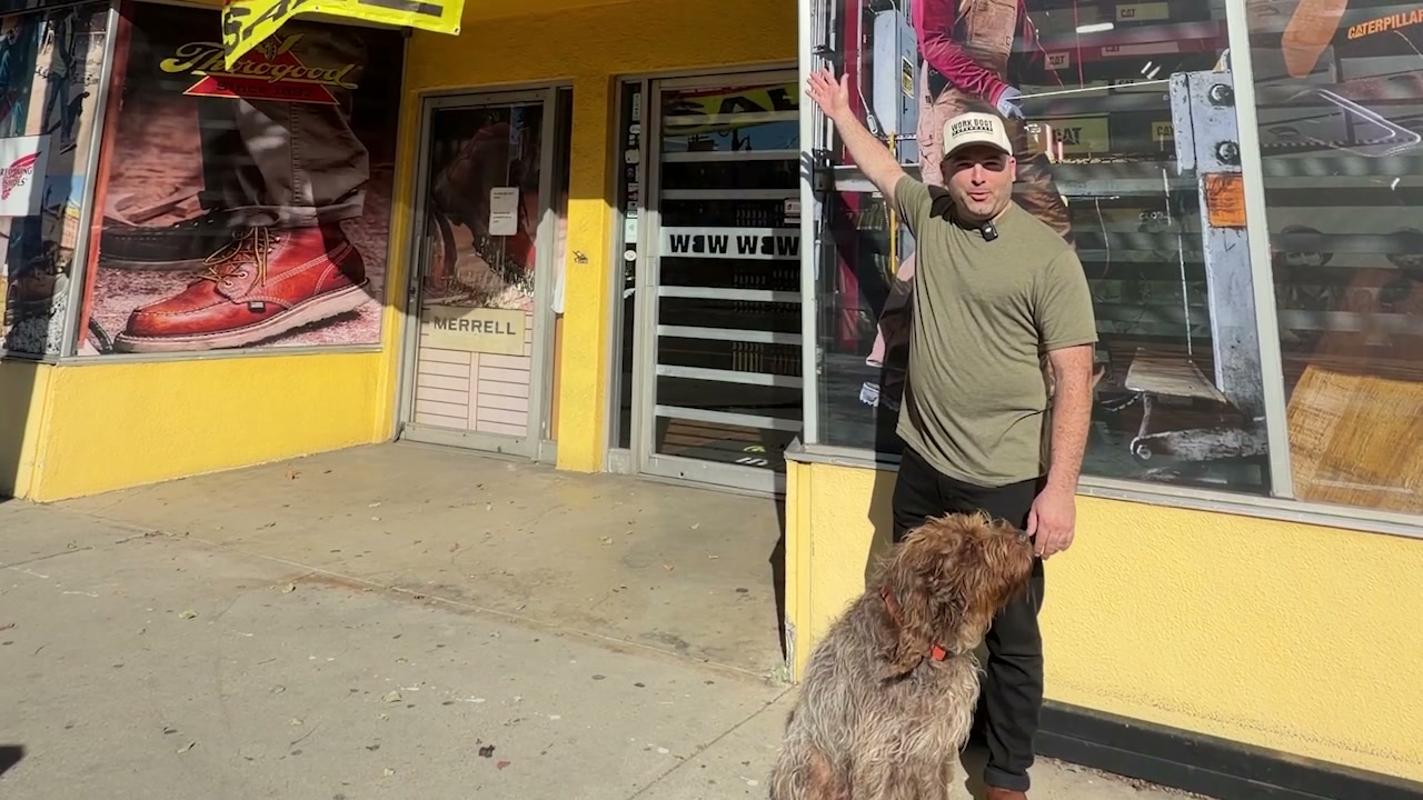 Michael Gruber and his dog Charlie outside the Work Boot Warehouse storefront in Canoga Park
