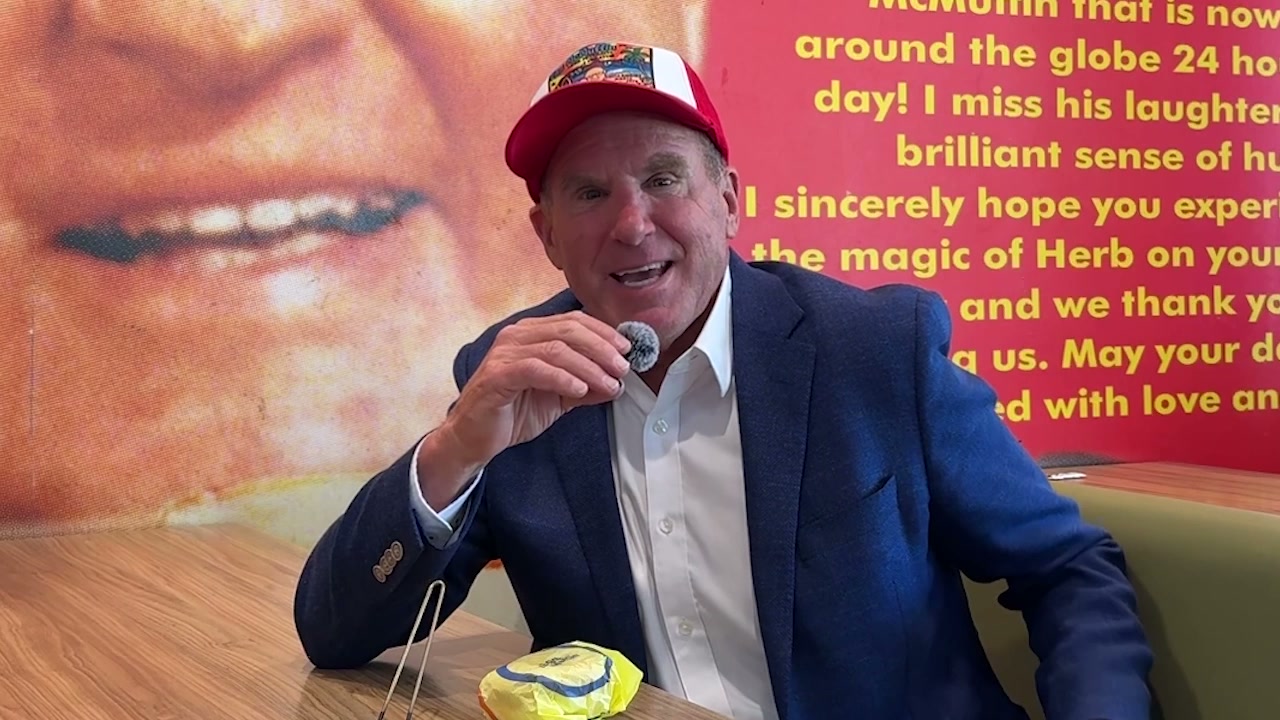 David Peterson in front of the mural honoring his dad Herb, inventor of the Egg McMuffin, at McDonald's of Goleta