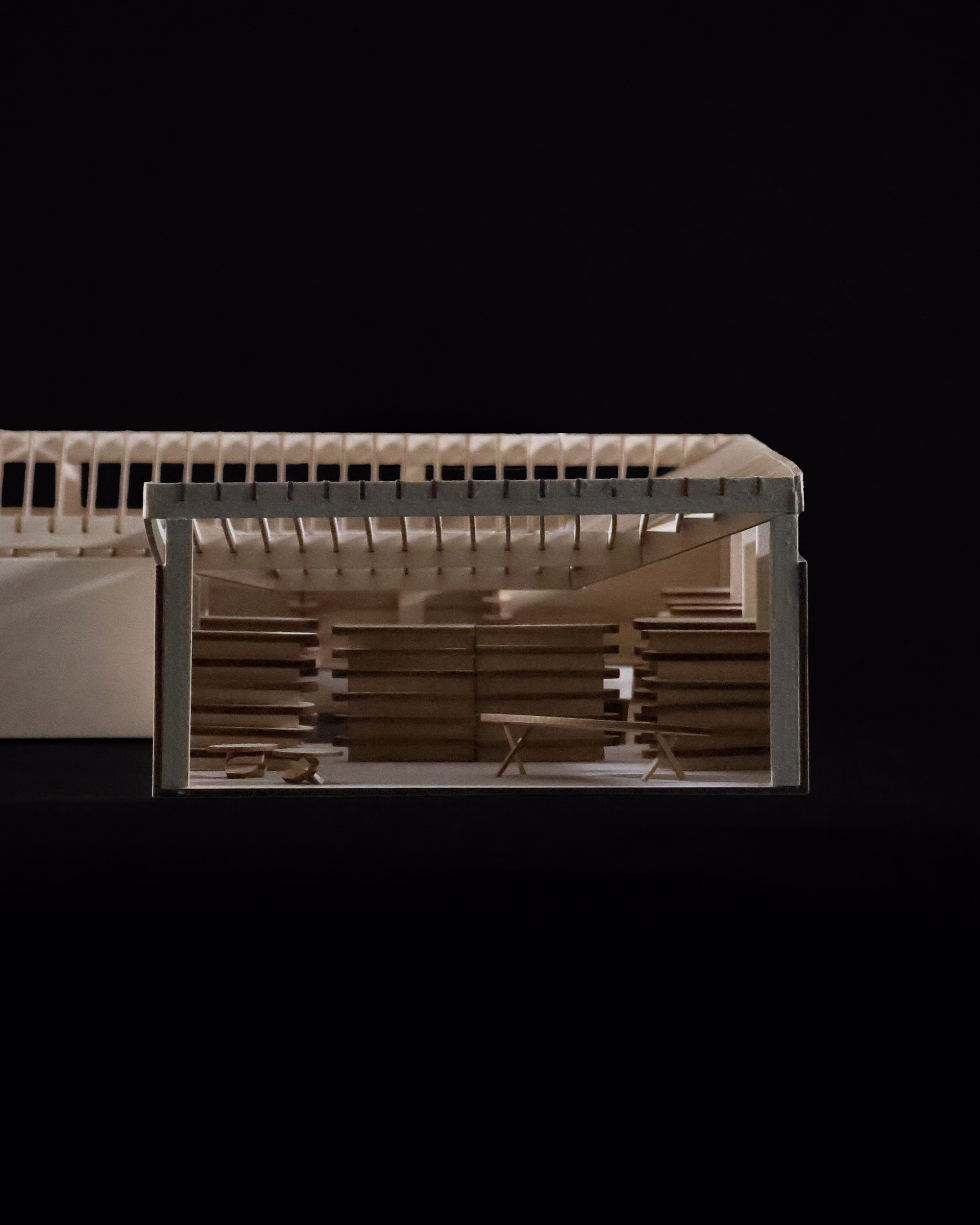 Close-up of the Jeffries Point Courtyard Library model, showing stepped seating beneath exposed roof rafters.