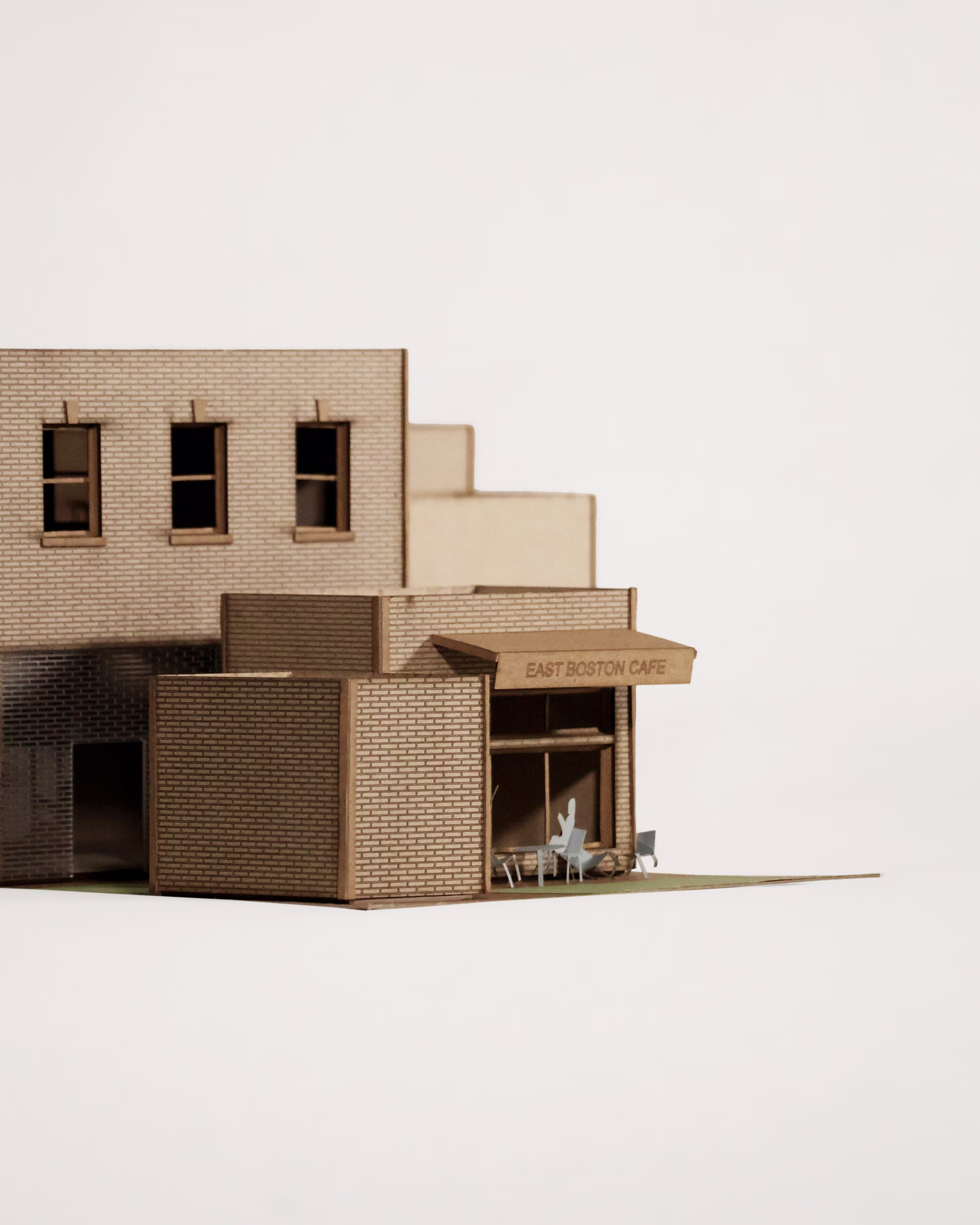 Corner detail of The Audio Alcove model, showing projecting volumes, windows and a sheltered ground-level space.