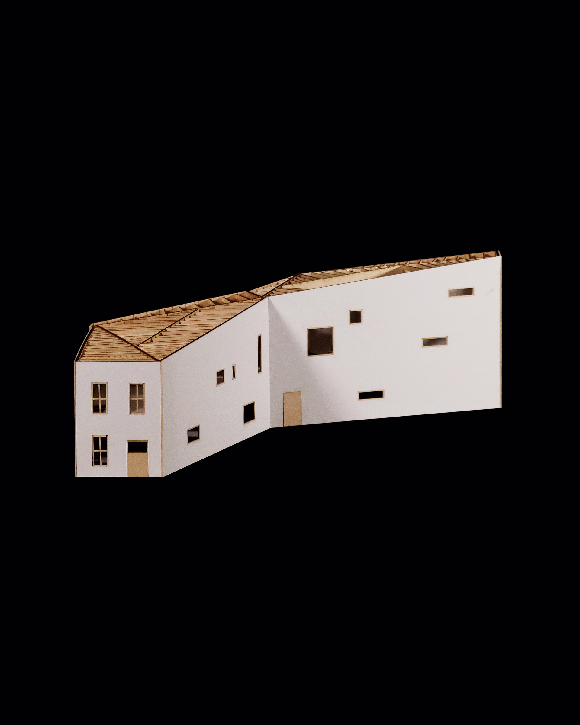 Oblique exterior elevation of the Spatial Transitions model, showing white walls with scattered window openings.
