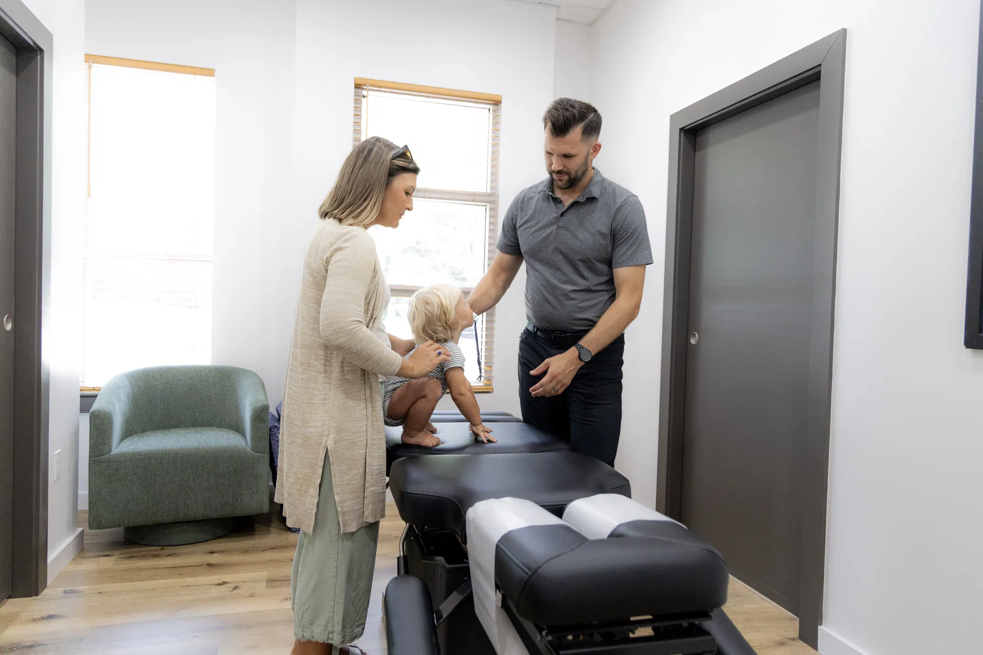 Dr. Jason O’Rear utilizing specialized pregnancy pillows at Limitless Chiropractic to ensure safe, face-down adjustments for Northshore moms.
