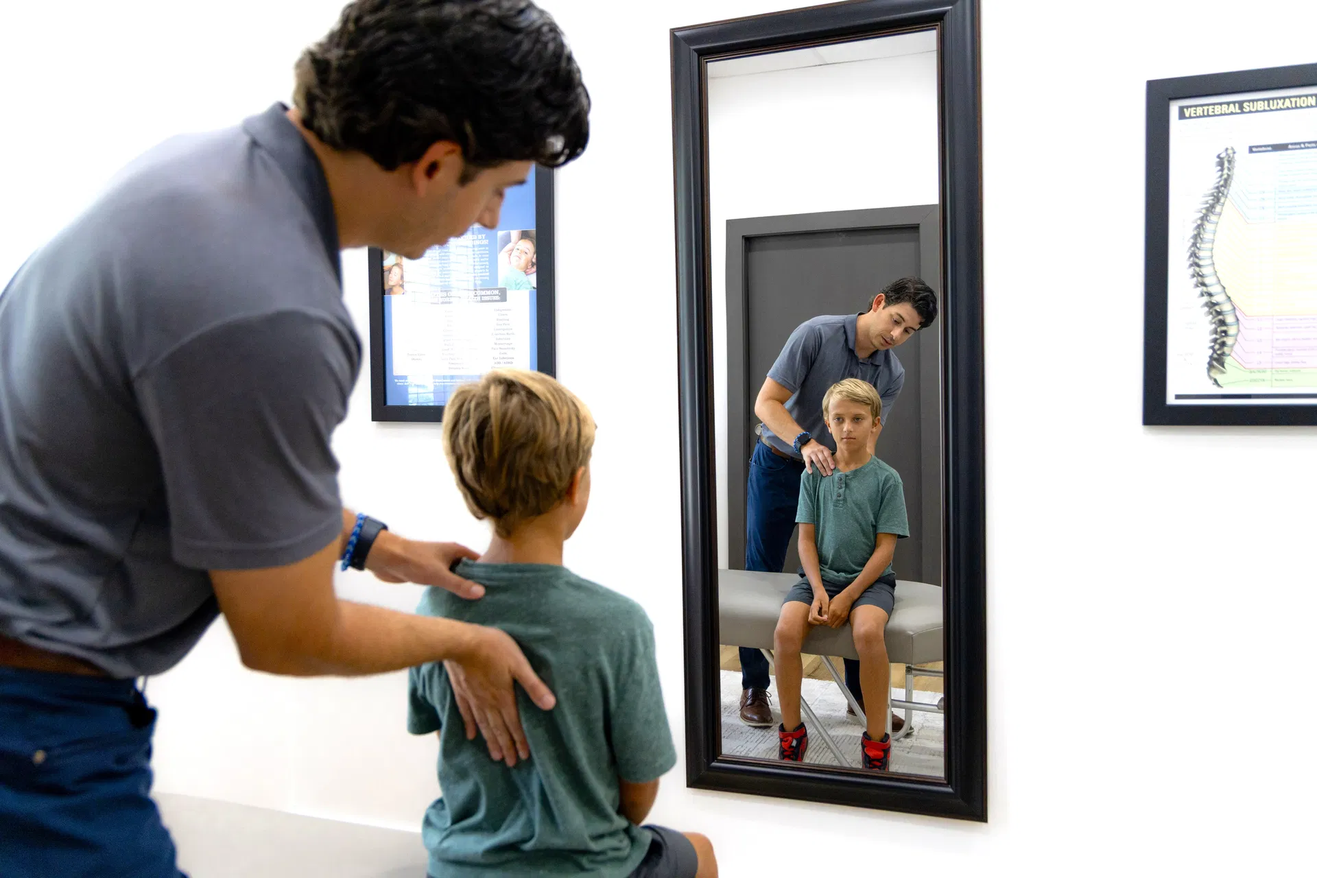 Sports chiropractor in Mandeville LA performing a dynamic extremity adjustment on a local athlete to improve range of motion.