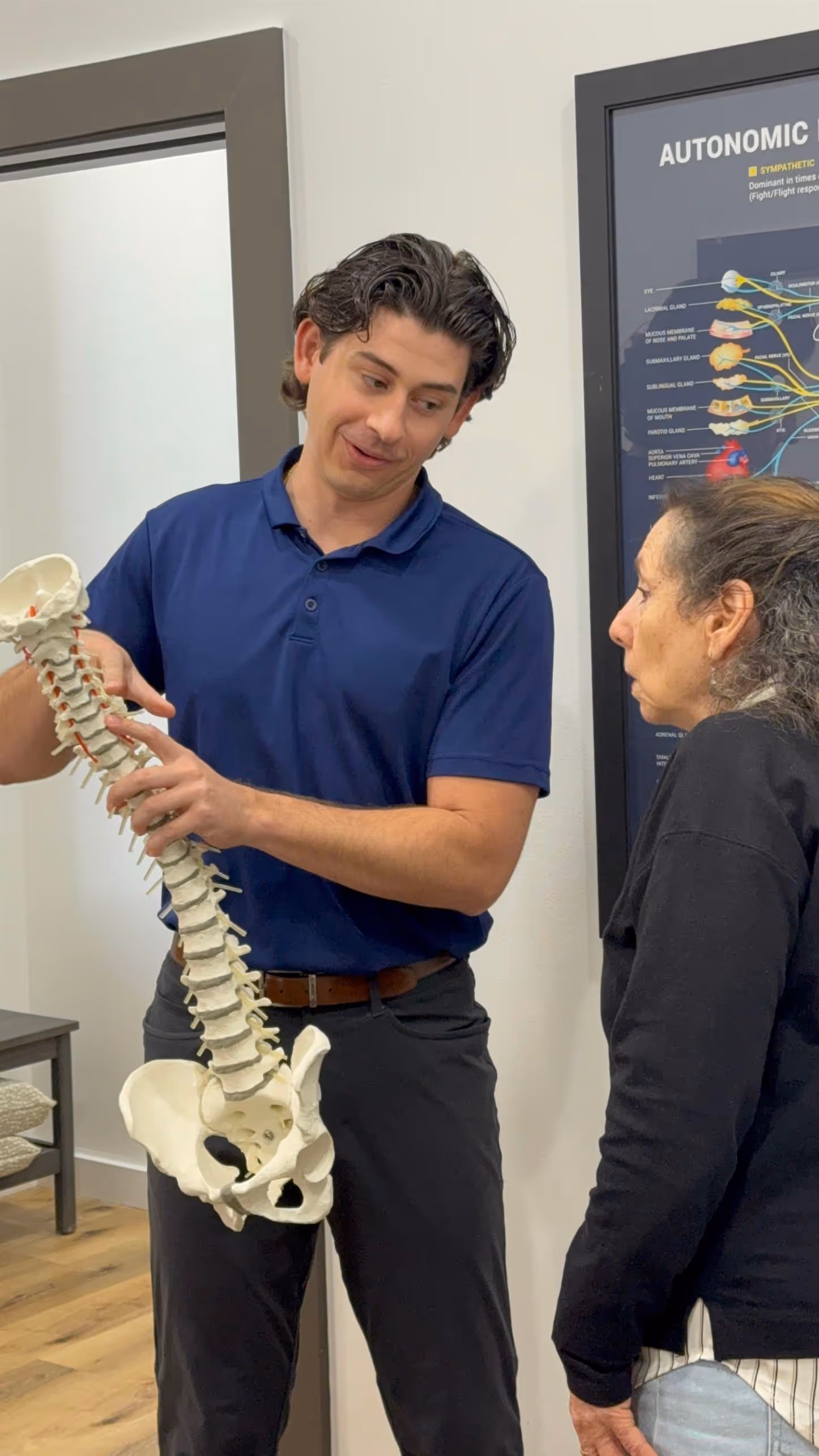 Dr. Thomas Bodin consulting with a Mandeville resident about postural correction and long-term spinal health goals.