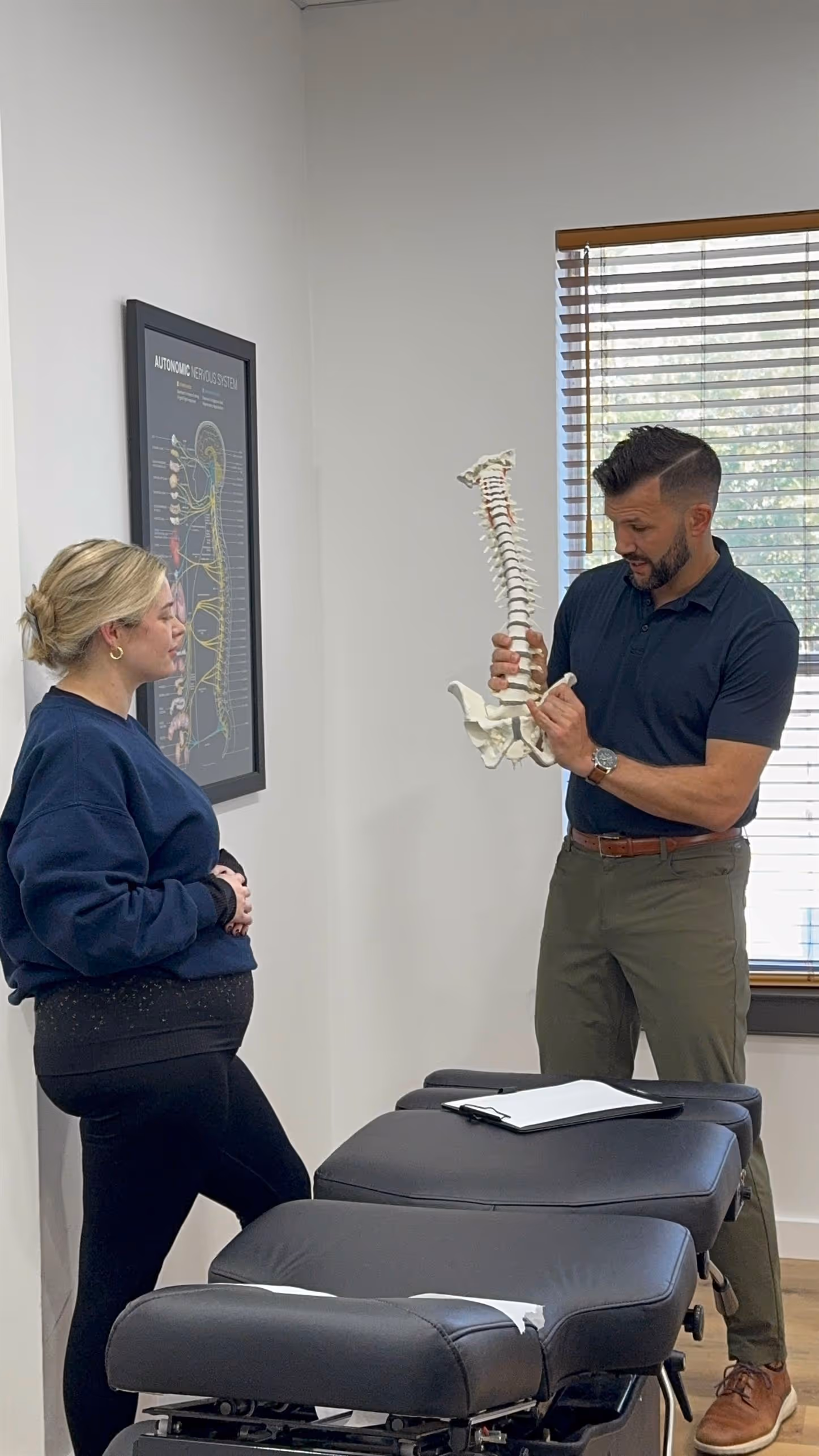 Dr. Jason O’Rear utilizing specialized pregnancy pillows at Limitless Chiropractic to ensure safe, face-down adjustments for Northshore moms.