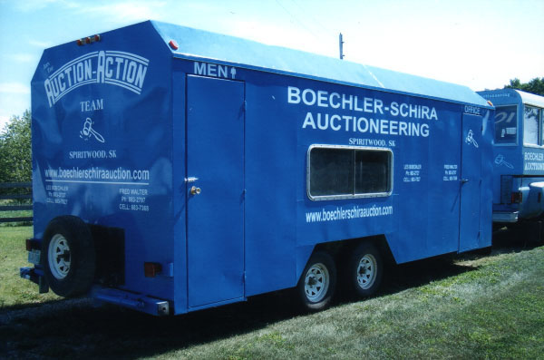 A blue truck is parked in the grass.