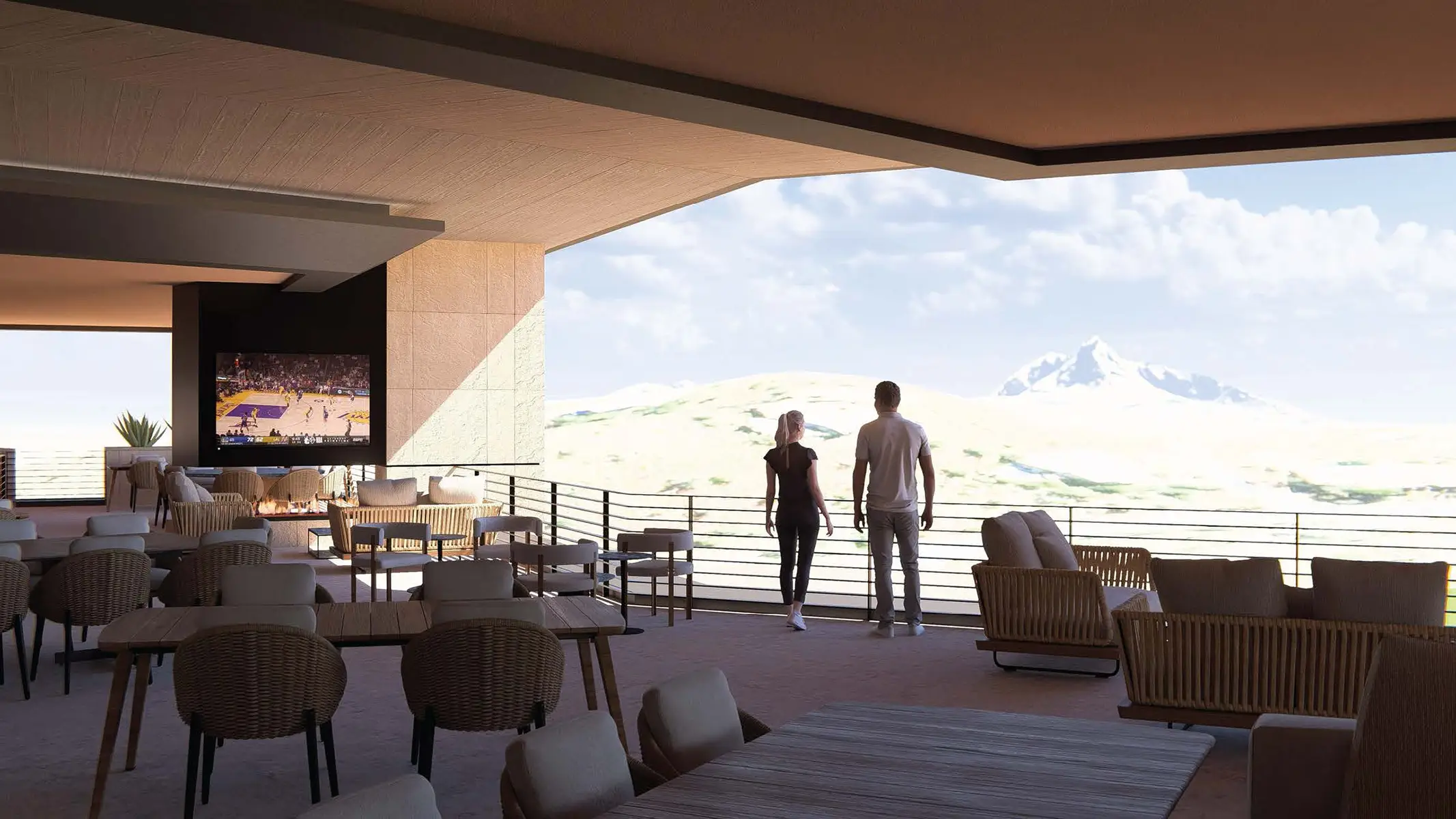 Couple stands on a spacious outdoor terrace with wicker chairs, tables, and mountain views.
