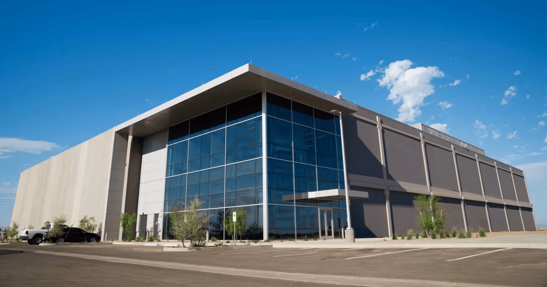 Exterior of a large data center building under a blue sky in a desert setting