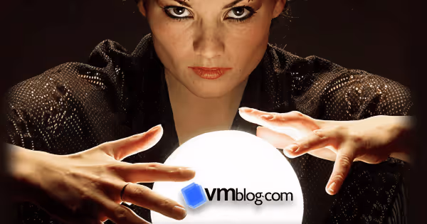 Woman in dark clothing holding a glowing crystal ball with the VMblog.com logo