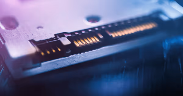Close-up of a glowing fiber optic connector with blue and purple light streaks