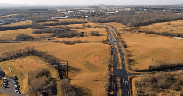 Aerial view of open farmland and a highway intersection in a rural Virginia setting