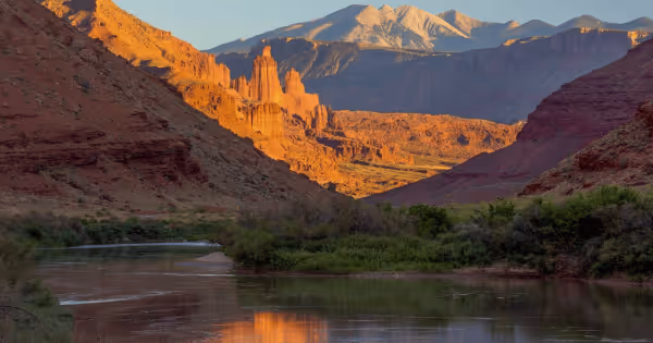 Aerial view of the Colorado River winding through red rock canyon terrain at dusk