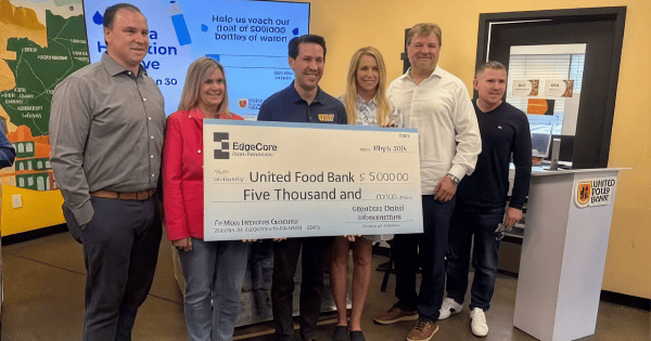EdgeCore team members presenting a $5,000 check to United Food Bank at a bottled water donation drive event