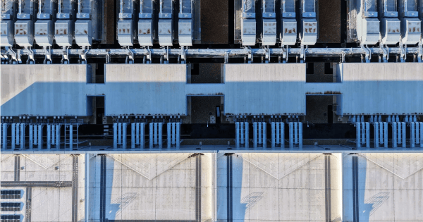 Aerial view of a data center rooftop with rows of mechanical cooling units