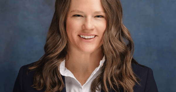 Professional headshot of a woman in a navy blazer