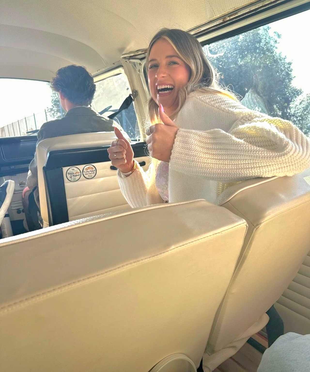 Guests cheering and laughing inside the restored VW bus on a Van'N Boozy Mocktail Tour in Temecula.