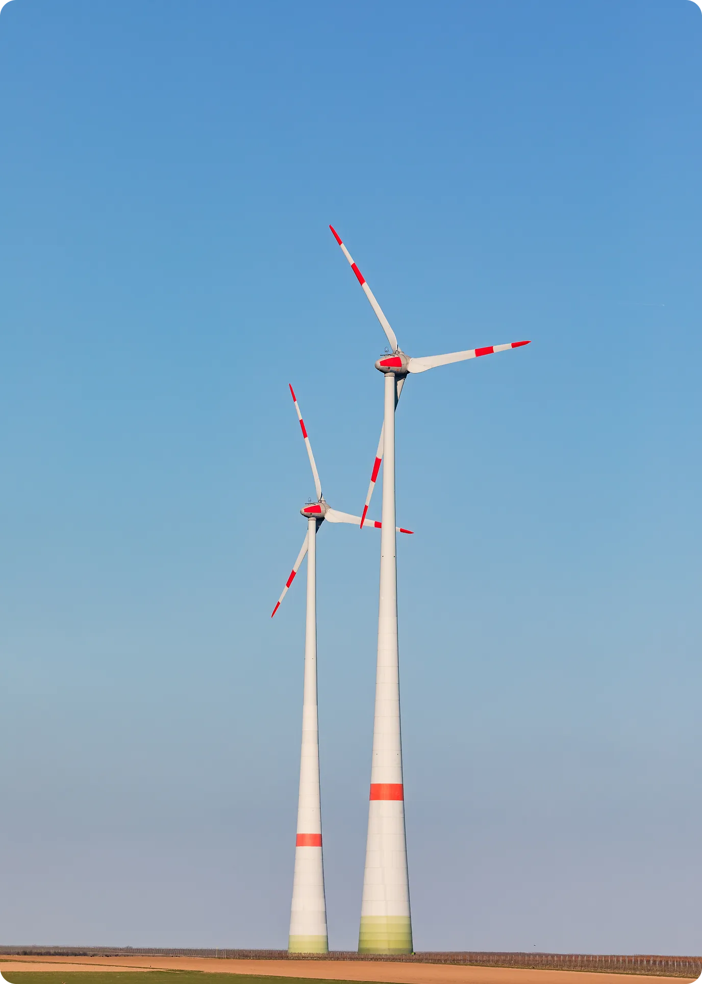 Solar panels and wind turbines under a blue sky generating renewable energy.