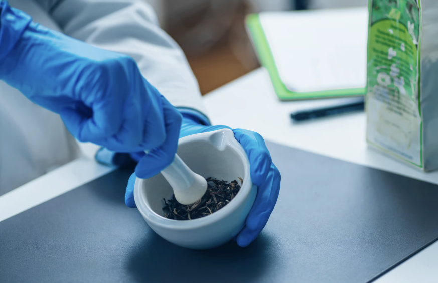 pharmacist using pestle & mortar