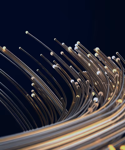 Two people shaking hands in a business setting with blurred colleagues in the background.