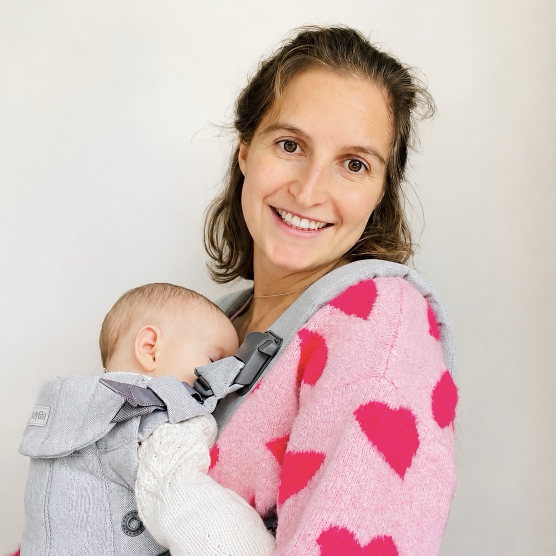 Charlotte carrying her baby in a sling