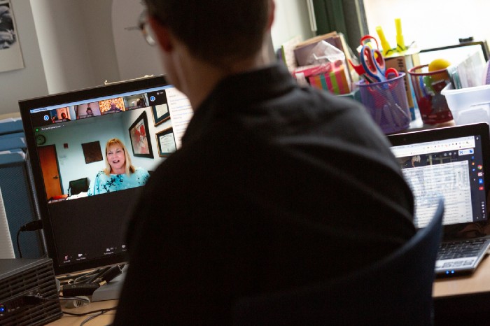 Teachers collaborate virtually using video conferencing software while their school is using hybrid instruction.