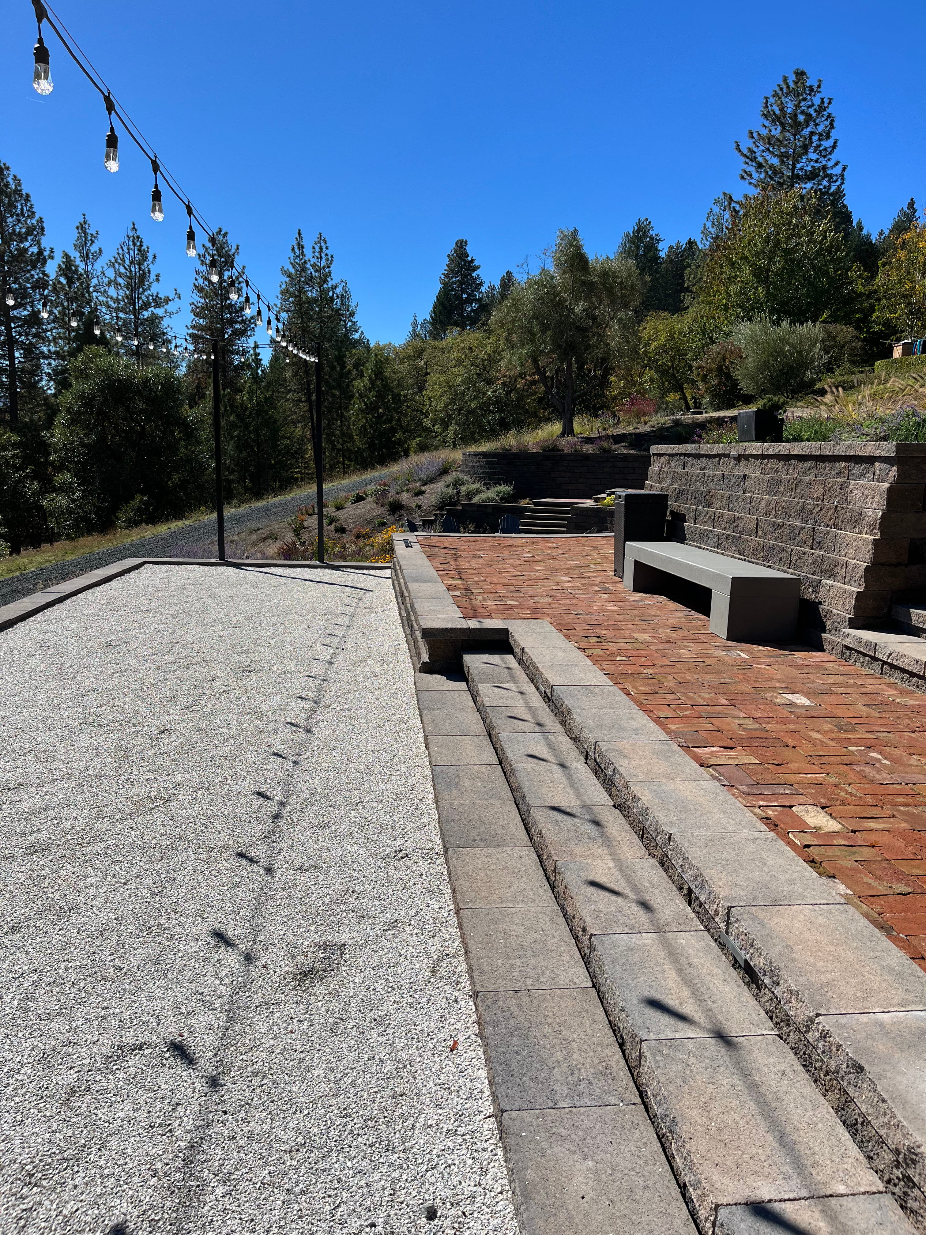 Fire pit gathering area set within a terraced landscape
