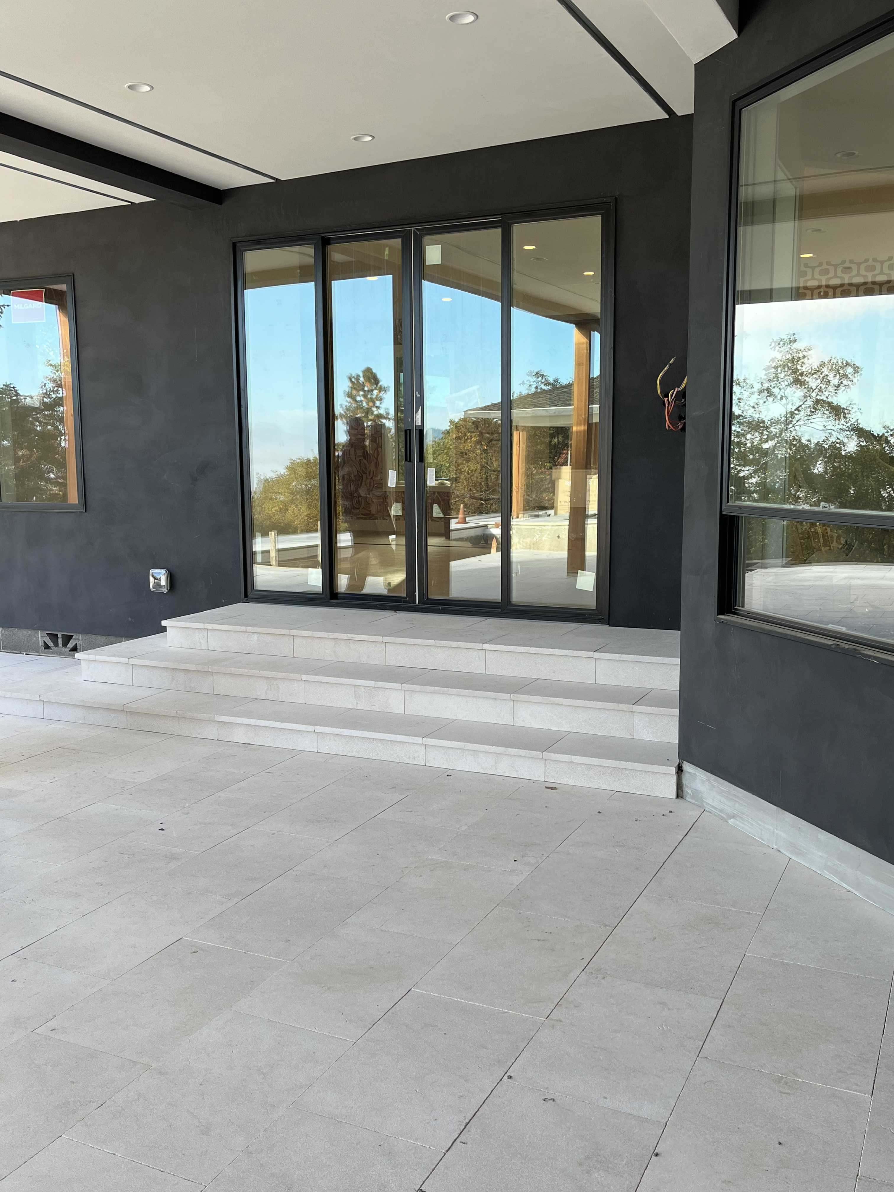 Sloped backyard with structural hardscape and outdoor kitchen