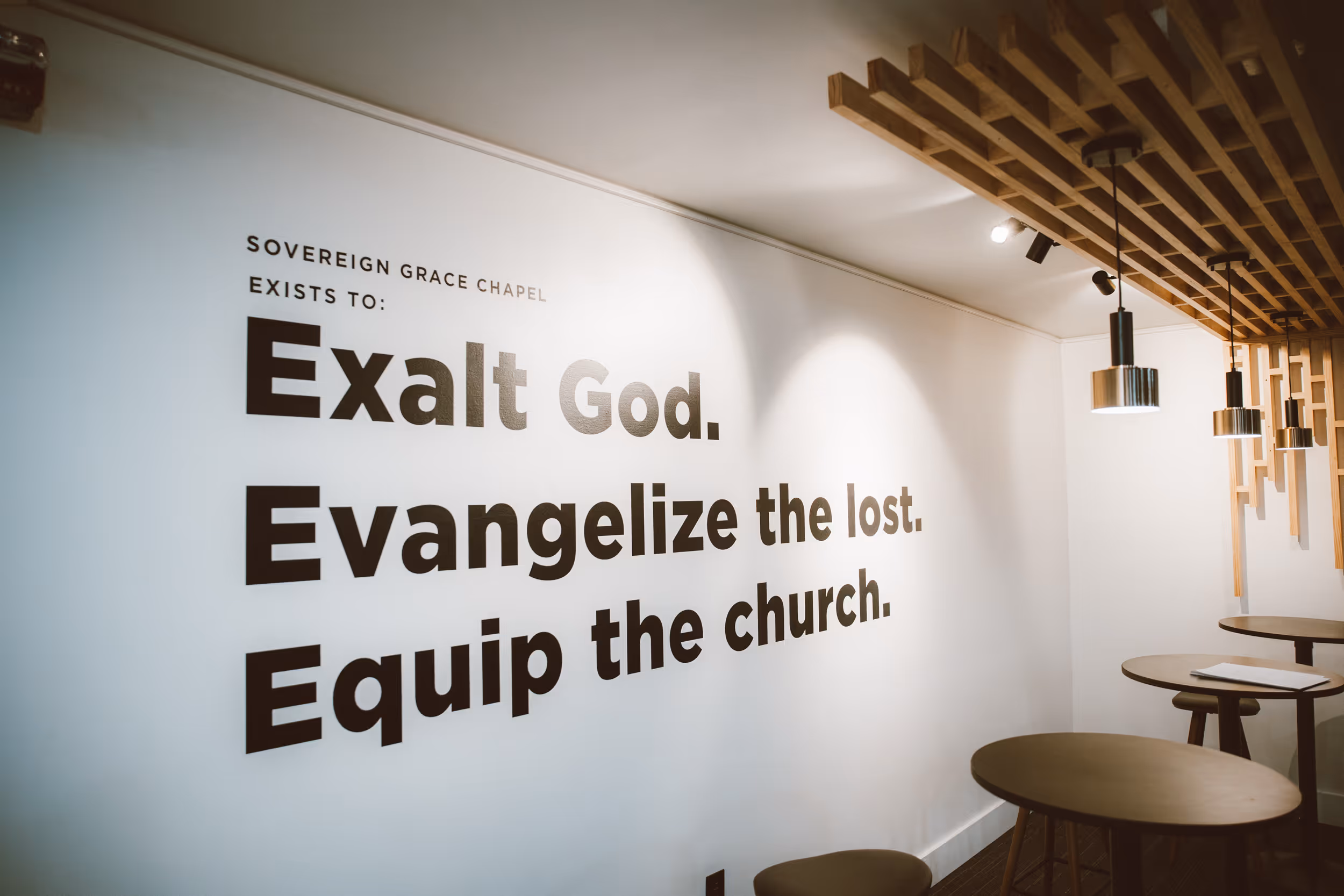 Sanctuary with pastor preaching in front of congregants from the stage.