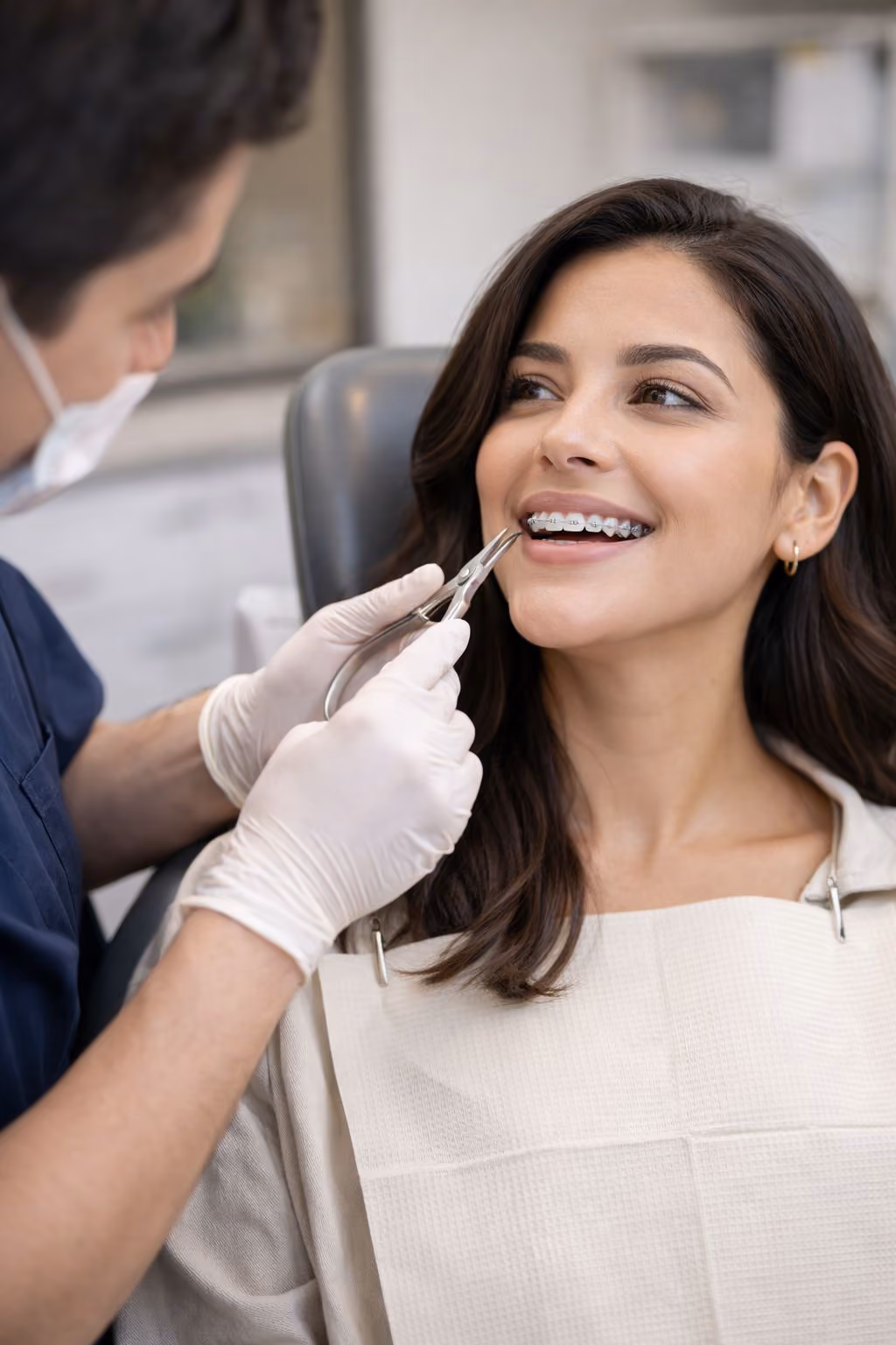 Paciente femenina recostada en sillón dental durante ajuste de ortodoncia discreta en clínica Allo Dental Tijuana