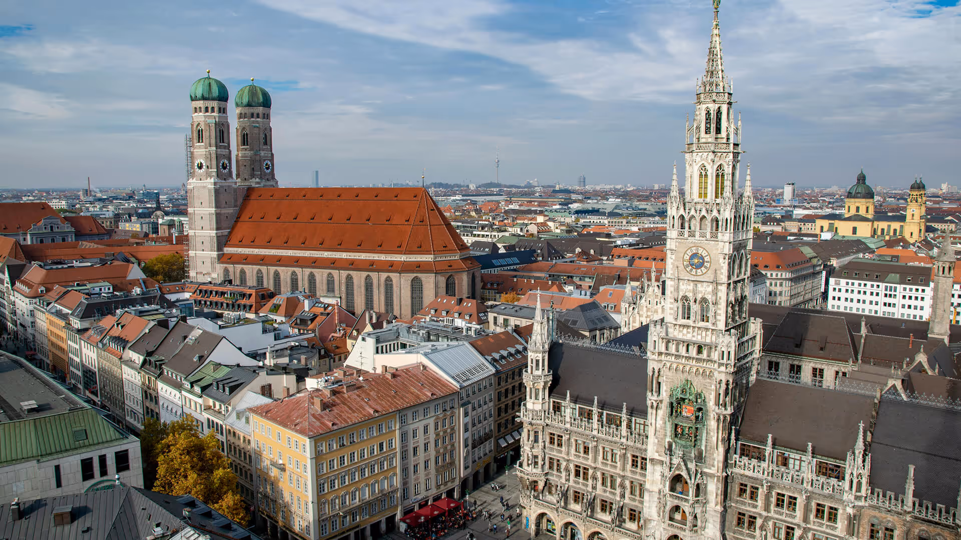 Munich's Marienplatz with New Town Hall tower, Frauenkirche green domes, and red-roofed buildings