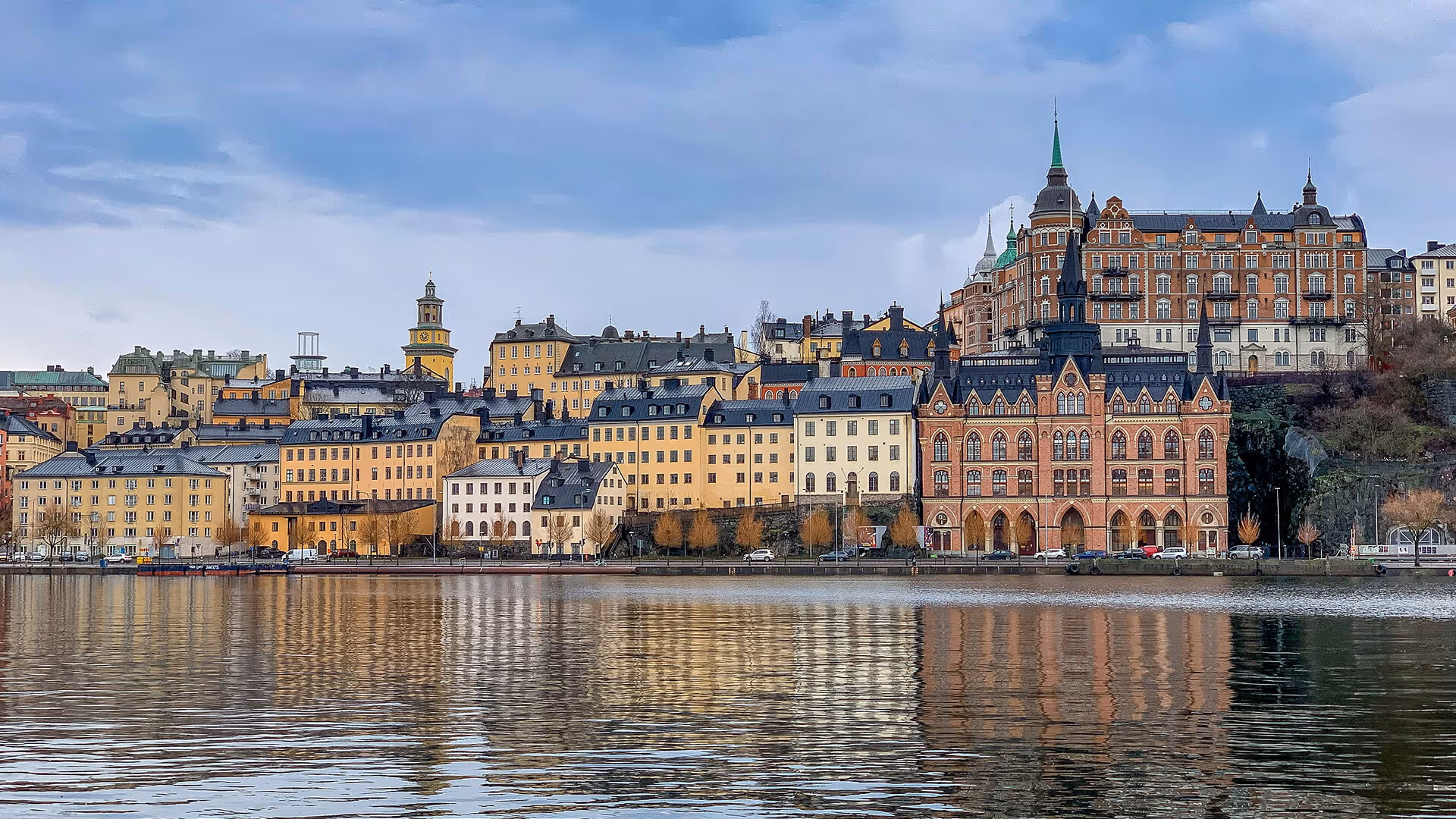 Stockholm Gamla Stan colorful historic buildings and grand palace reflected in calm waterfront bay