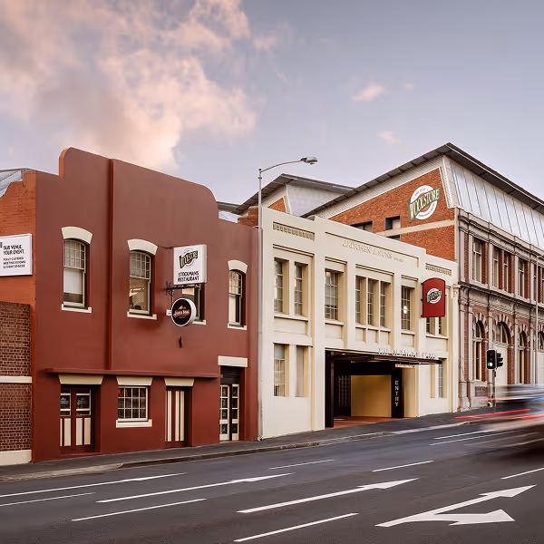 A red brick hotel at sunset.