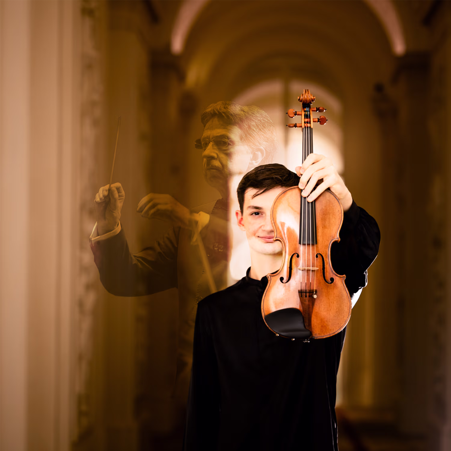 A young man in a black shirt stands in an arched hallway holding a violin upright in front of his face. Behind him, a faint double exposure image shows conductor Eivind Aadland in mid-gesture, adding a layered, artistic effect.