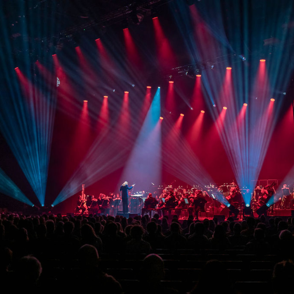 A major stage show with red and blue lights.