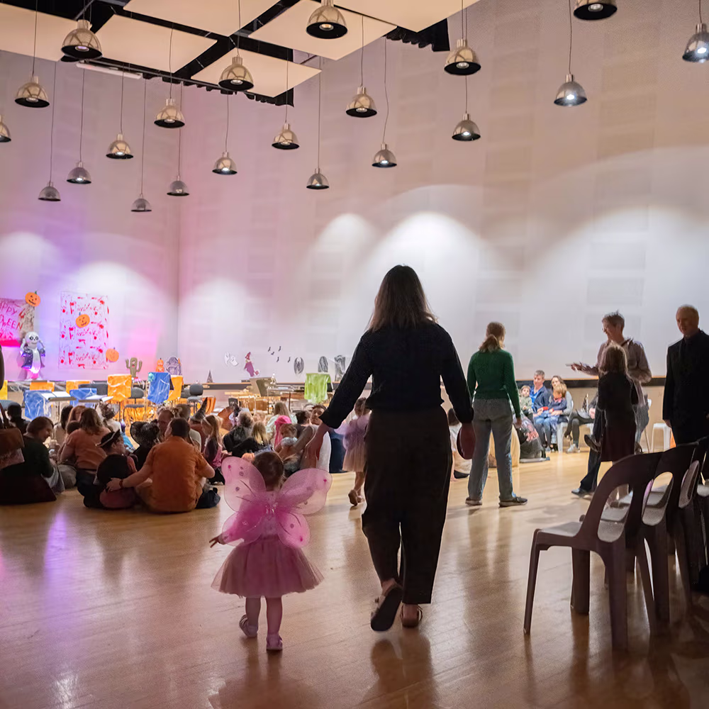 A little girl and woman walking into a concert in the TSO Studio.
