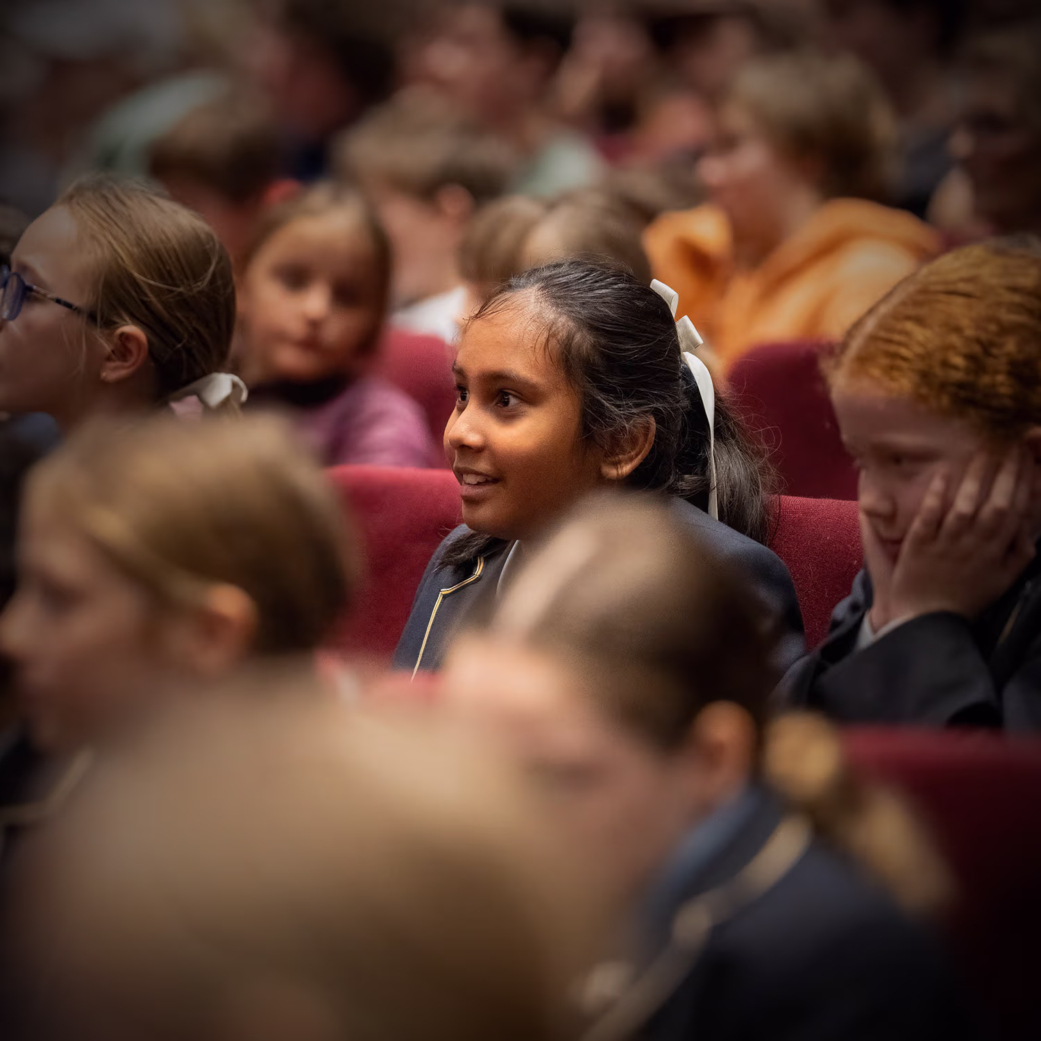 Engaged school children in a concert hall.