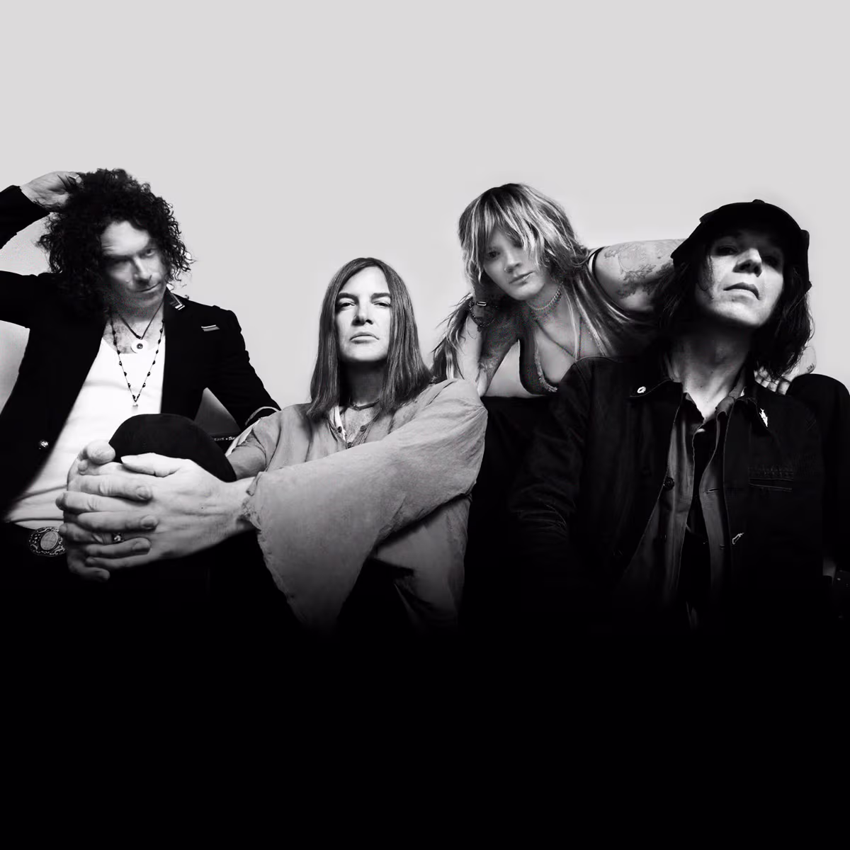 Black and white photo of four alt rock musicians.
