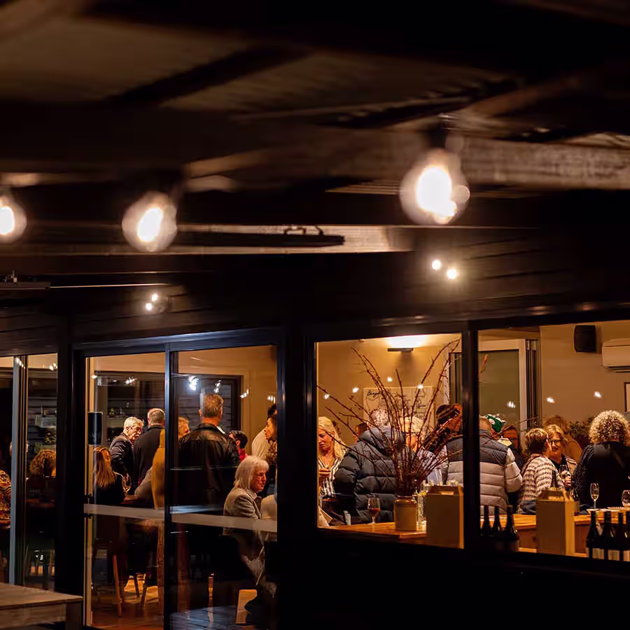 Looking into a cozy, warm-lit vineyard shed.