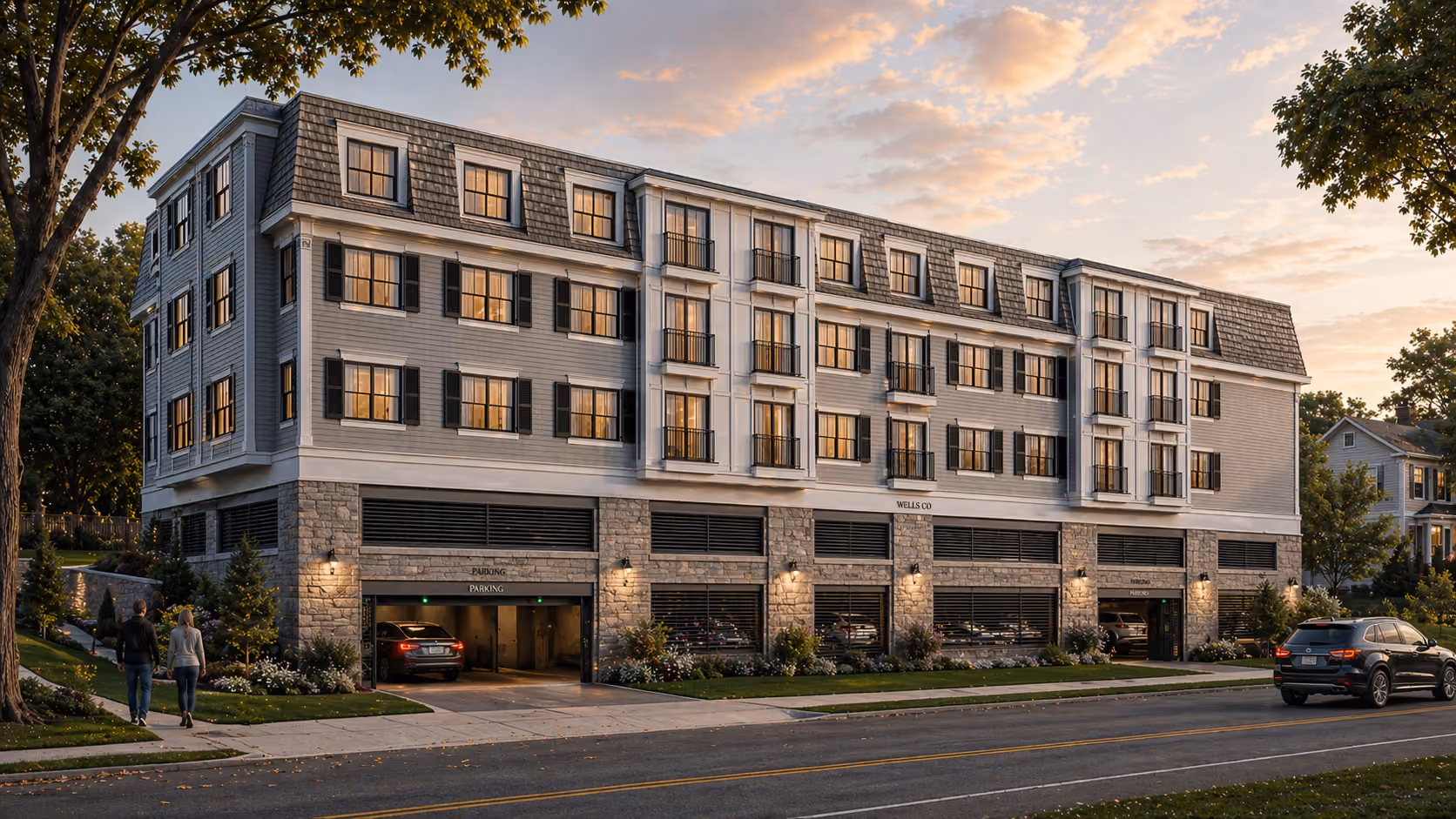 Four-story residential building with parking garage, cars, landscaping, and two people walking on sidewalk.