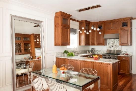 An image of a kitchen and dining area with hanging pendant lights over the counter bar.